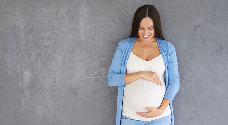 A young surrogate mom standing on the wall - Joy of Life Surrogacy