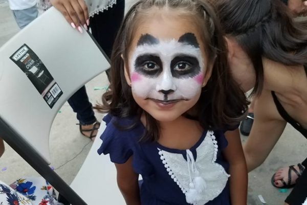 A little girl has panda face painting - Joy of Life Surrogacy
