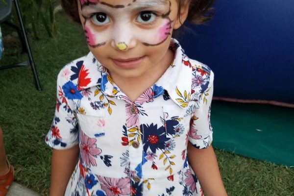 A little girl showing off her face painting - Joy of Life Surrogacy