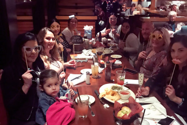 Surrogate mom taking picture with baby in front of table - Joy of Life Surrogacy