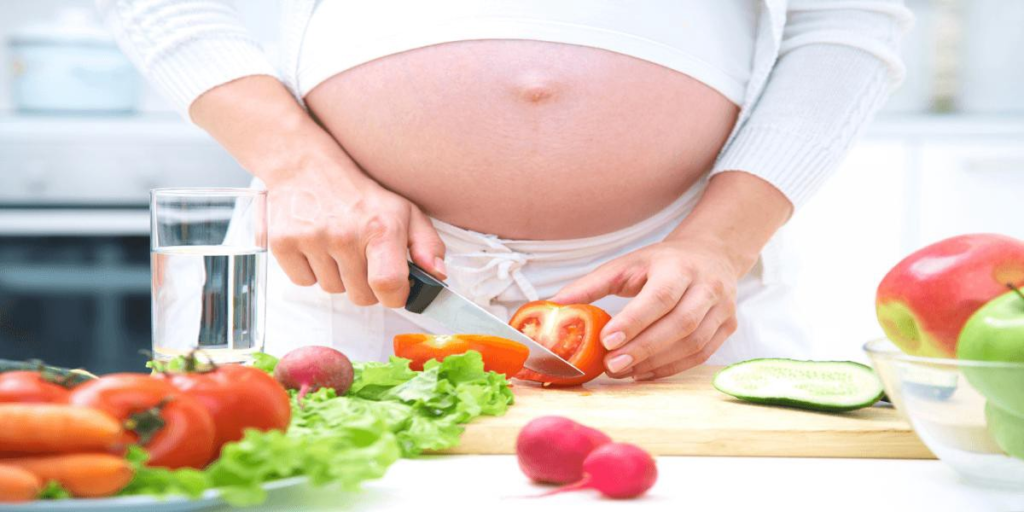 Pregnant mom preparing the salad - Joy of Life Surrogacy