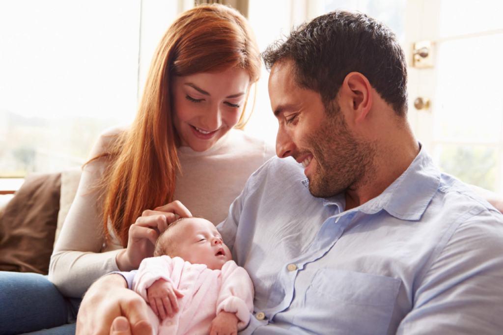 A parents holding their baby - Joy of Life Surrogacy