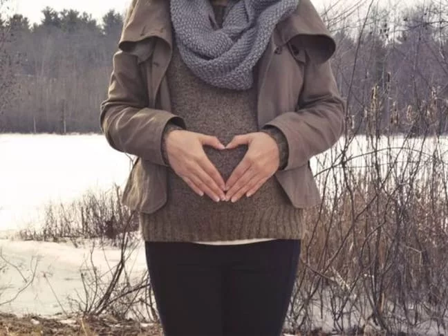 A Pregnant Women Standing in Front of Snow - Joy of Life Surrogacy