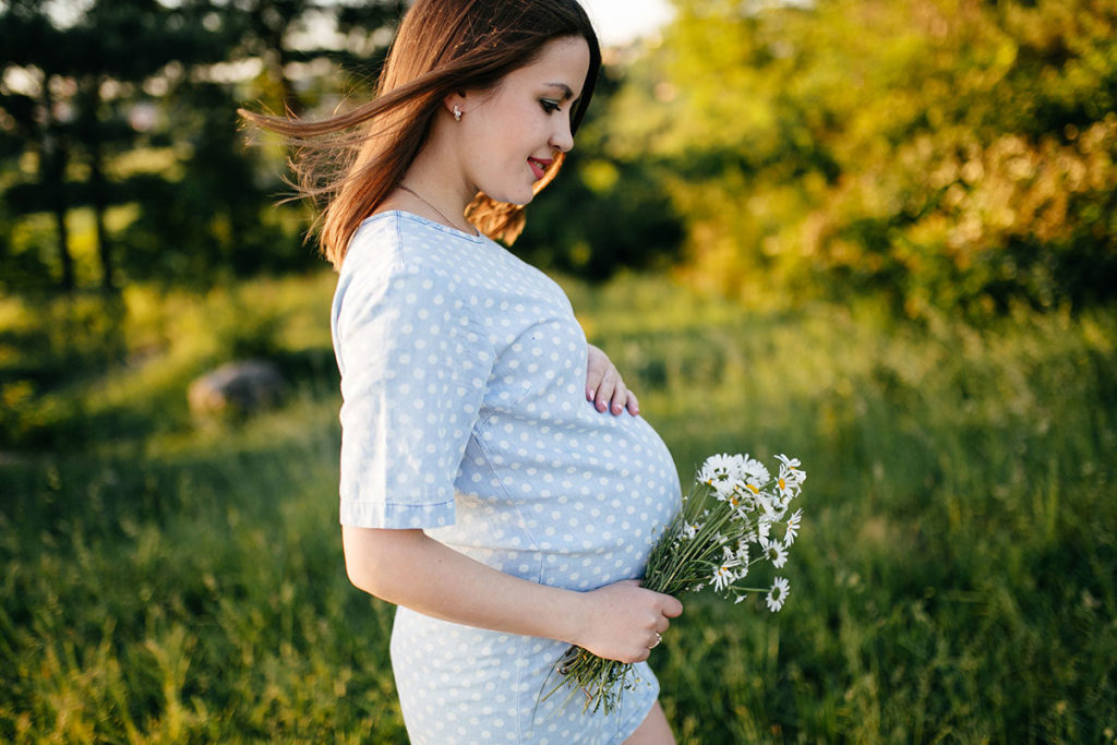 Surrogate mother walking on the underbrush - Joy of Life Surrogacy