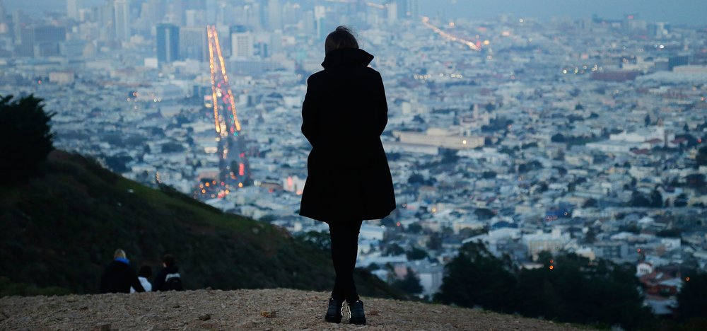A Surrogate Mom Wearing a Black Coat and Standing on the Mountain - Joy of Life Surrogacy