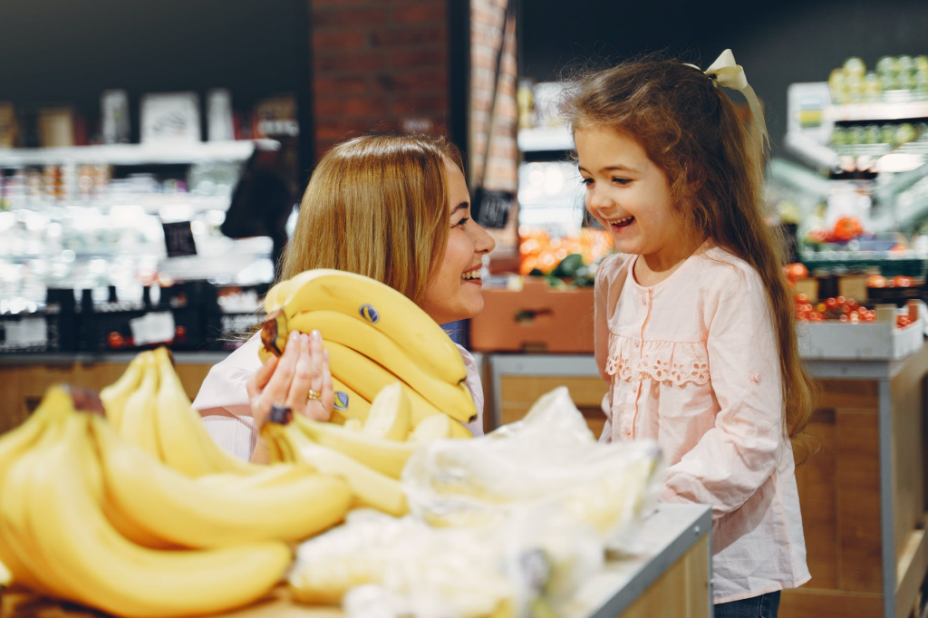 Mom and daughter standing in front of banana - Joy of Life Surrogacy