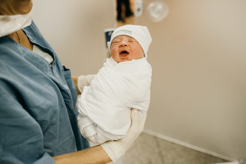 Mom hold her newborn baby - Joy of Life Surrogacy