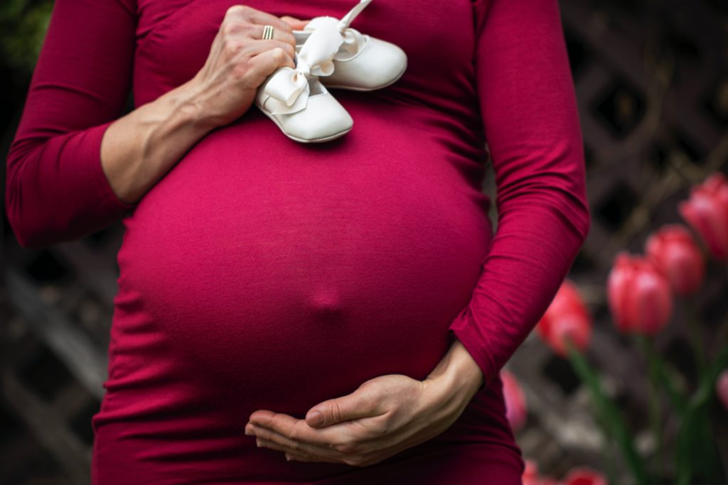 Pregnant mom wear red dress - Joy of Life Surrogacy